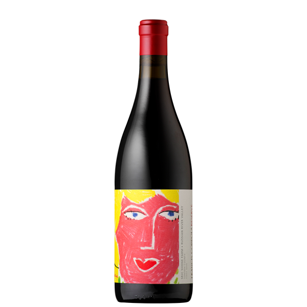 A wine bottle with a vibrant label featuring a colorful abstract face in red, yellow, and blue tones. It has a red cap and a minimalist design, set against a black background.