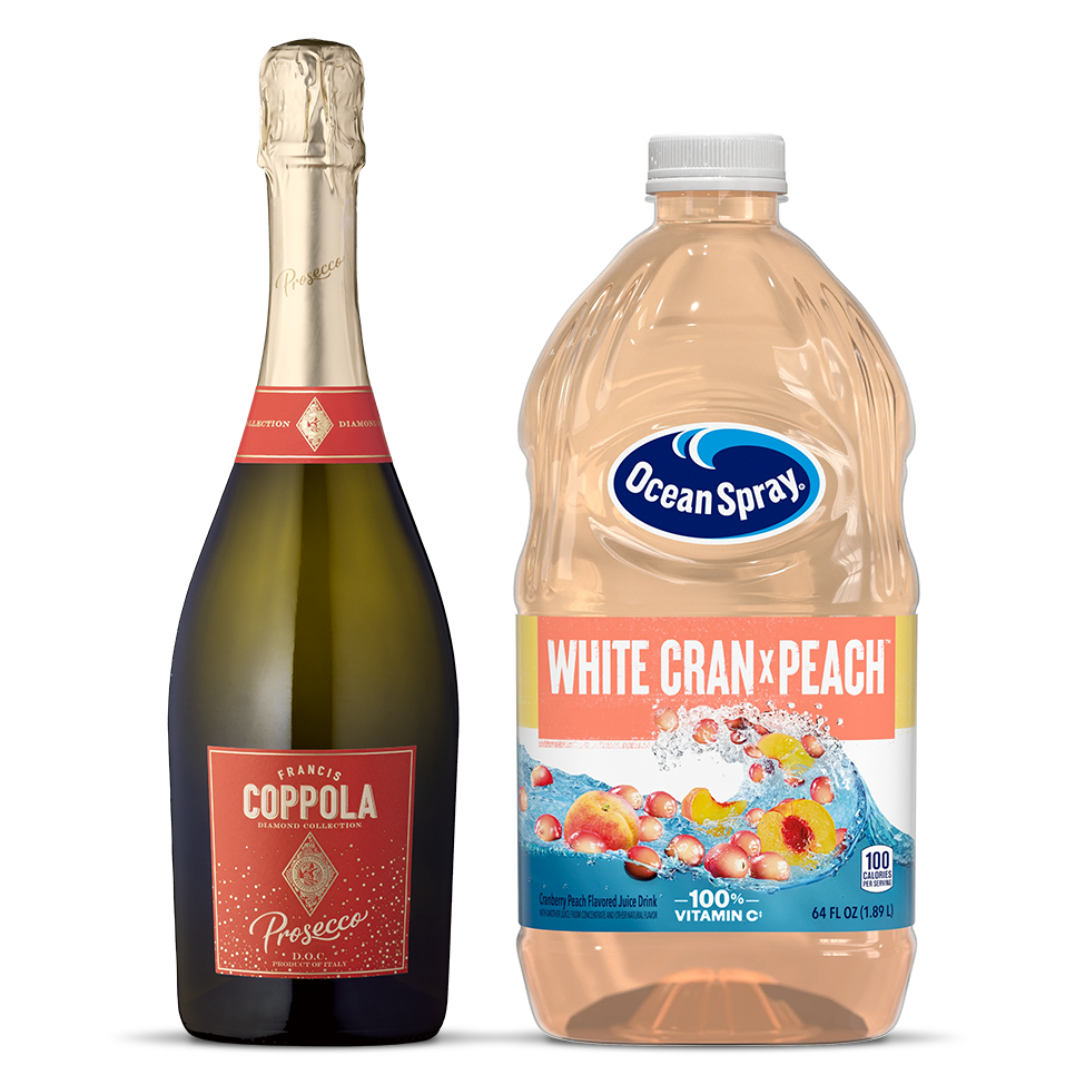 A bottle of Diamond Coppola Prosecco next to a bottle of Ocean Spray White Cran Peach juice